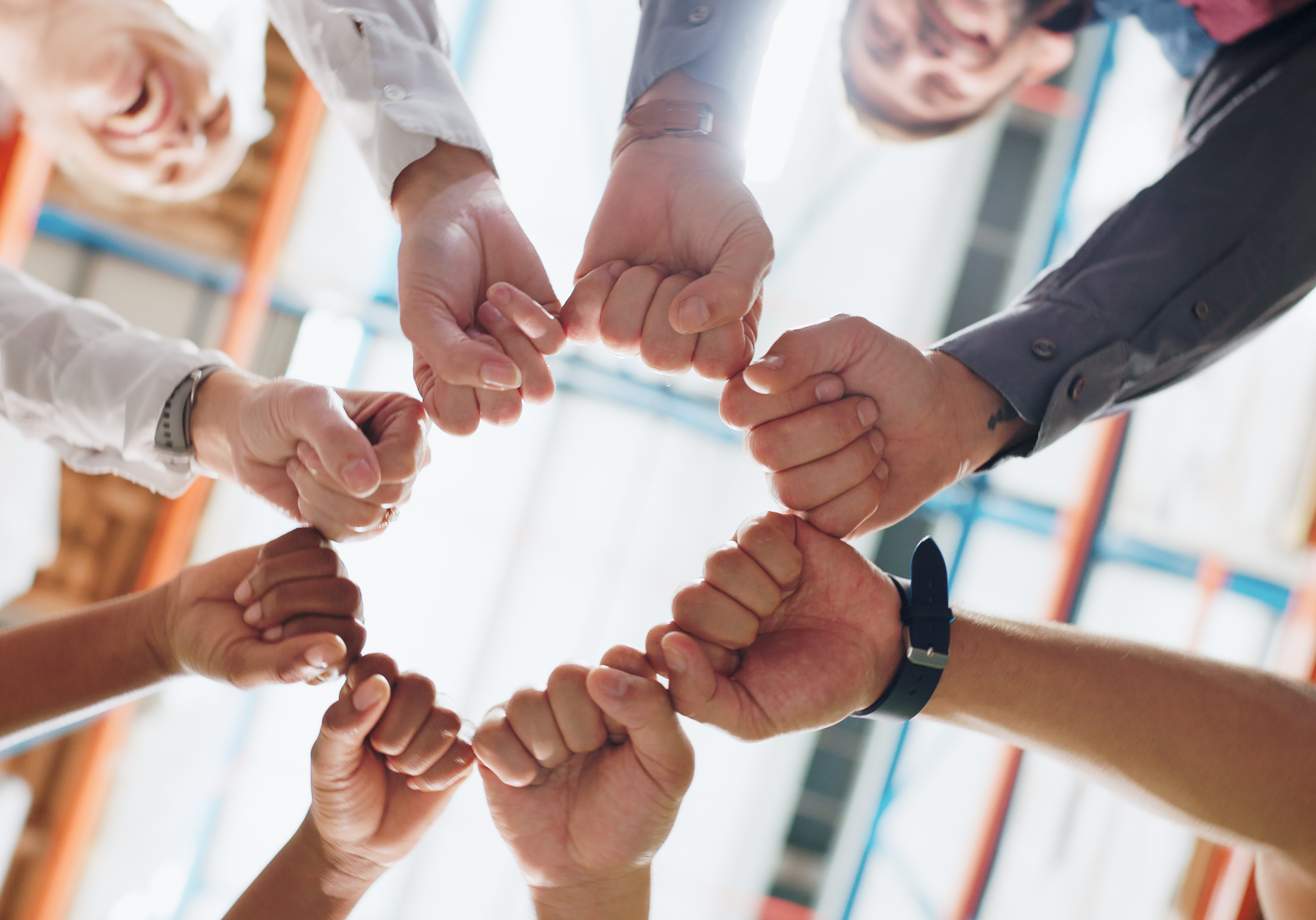 People, hands and fist bump in workplace for teamwork, collaboration and solidarity with synergy. Employee, circle and trust for strategy, partnership with support, diversity and mission in warehouse.